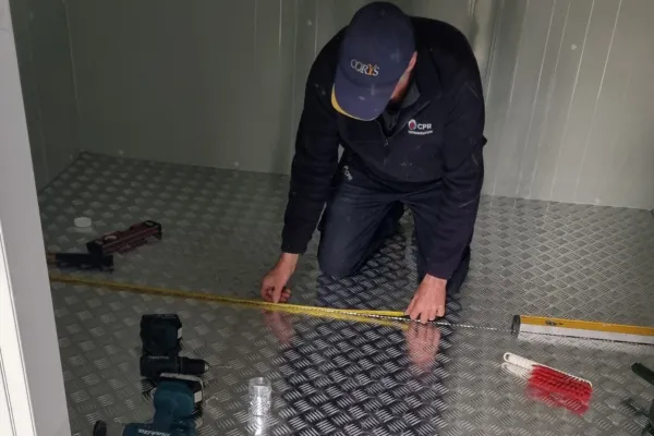 Staff Member Installing an Aluminium Floor in a Walk in Freezer
